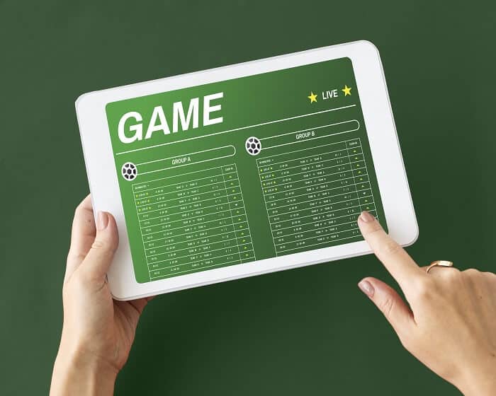 Tablet mit Fußballgruppenwetten